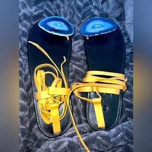 Leather sandals boast a quartz stone over each big toe.